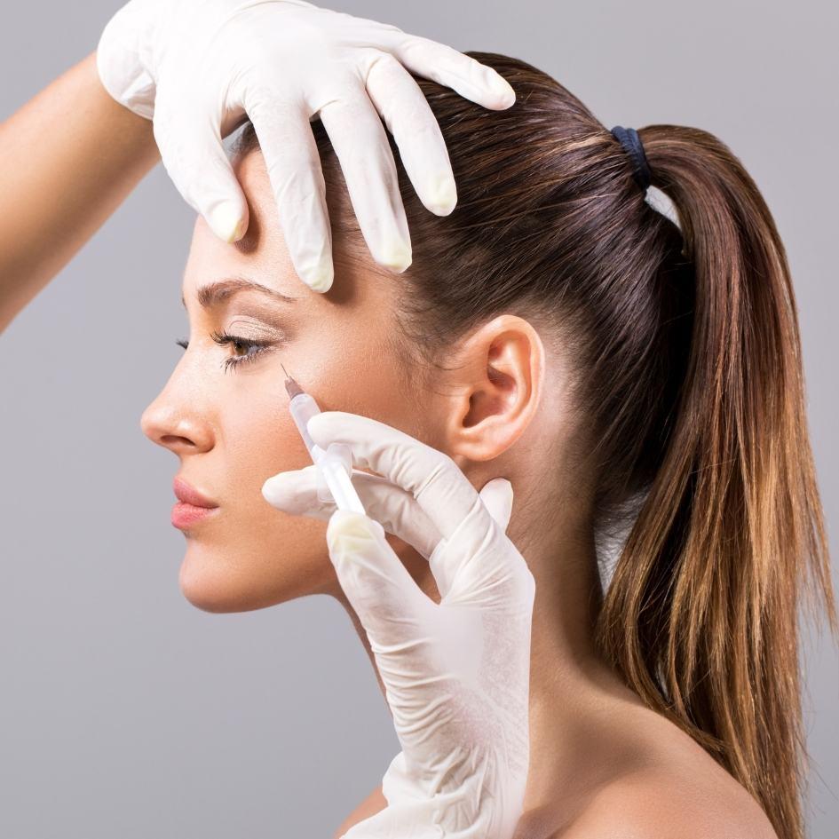 Woman receiving Botox injection on forehead to reduce wrinkles at Vibra Clinics