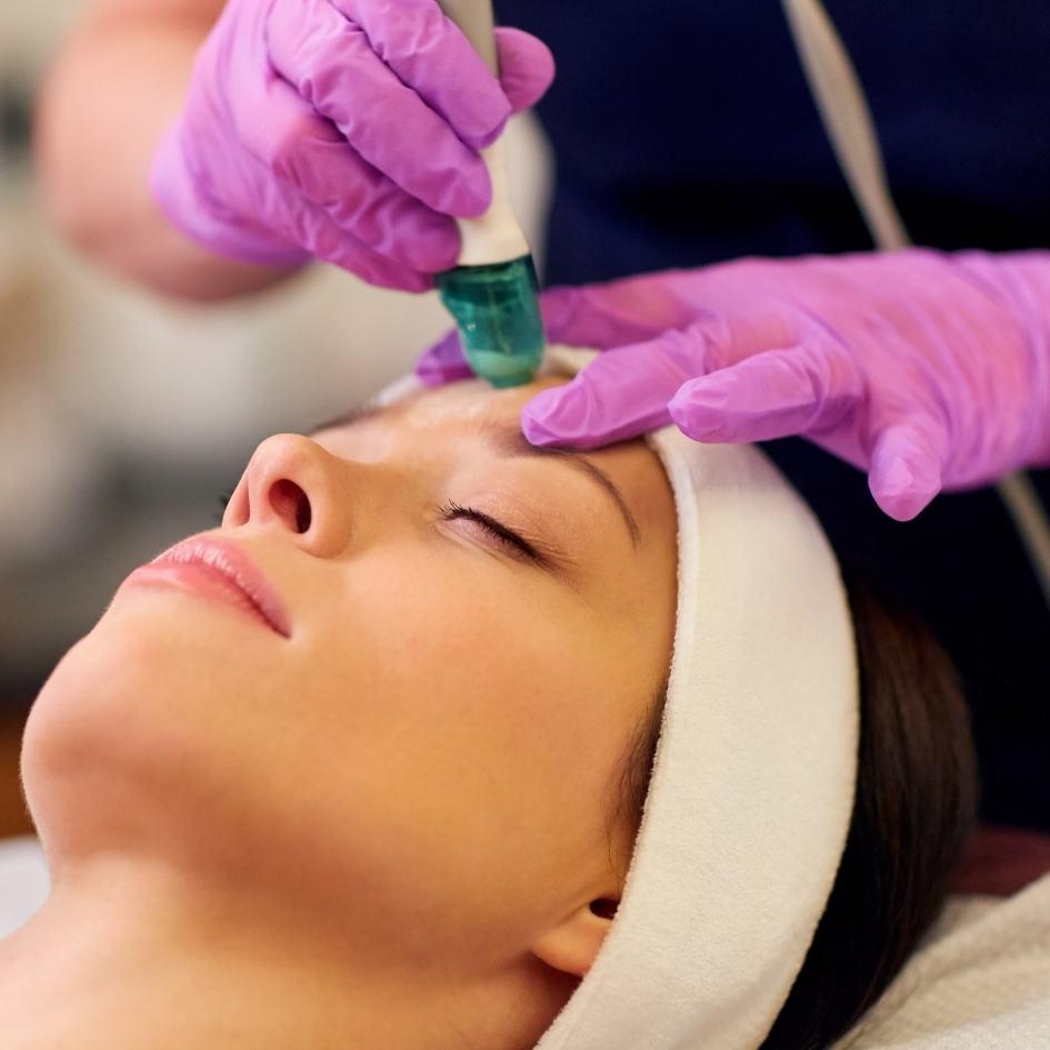 Client receiving a medi-facial treatment at Vibra Clinics for deep skin rejuvenation and radiant glow